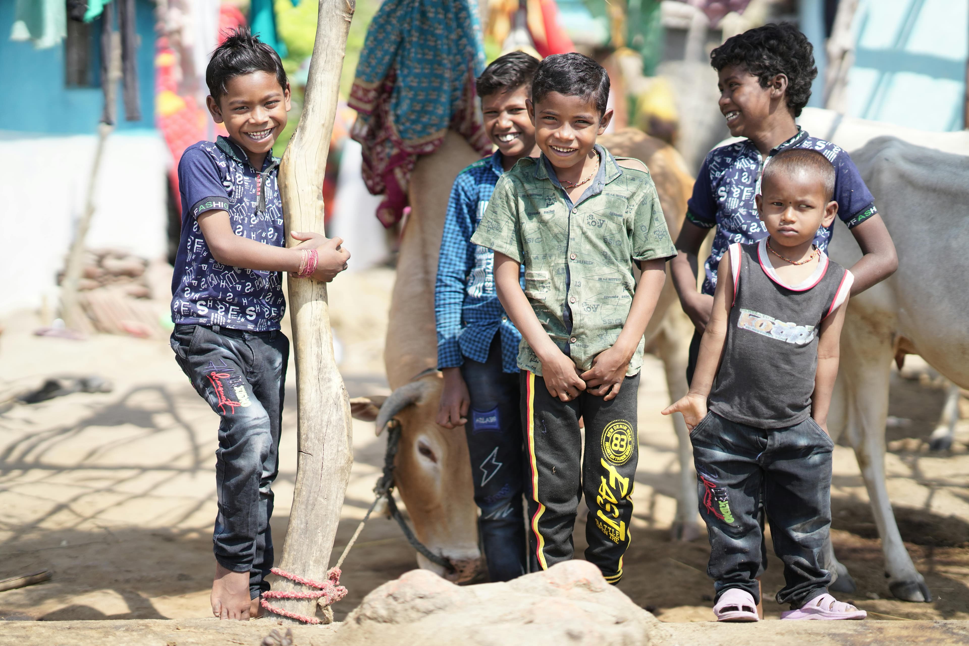 Children smiling together in a rural Indian village