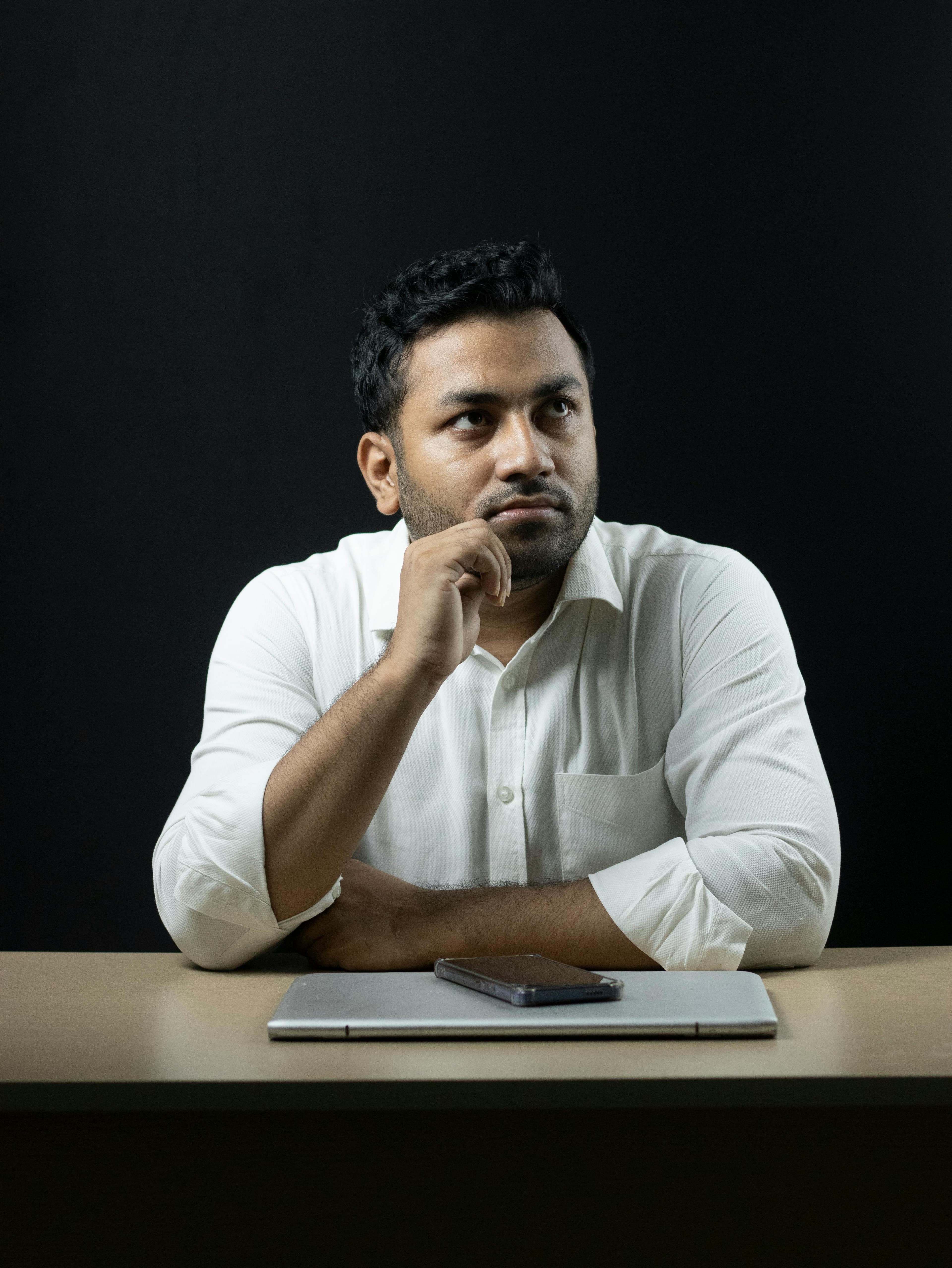 Indian professional reviewing application details at an office desk