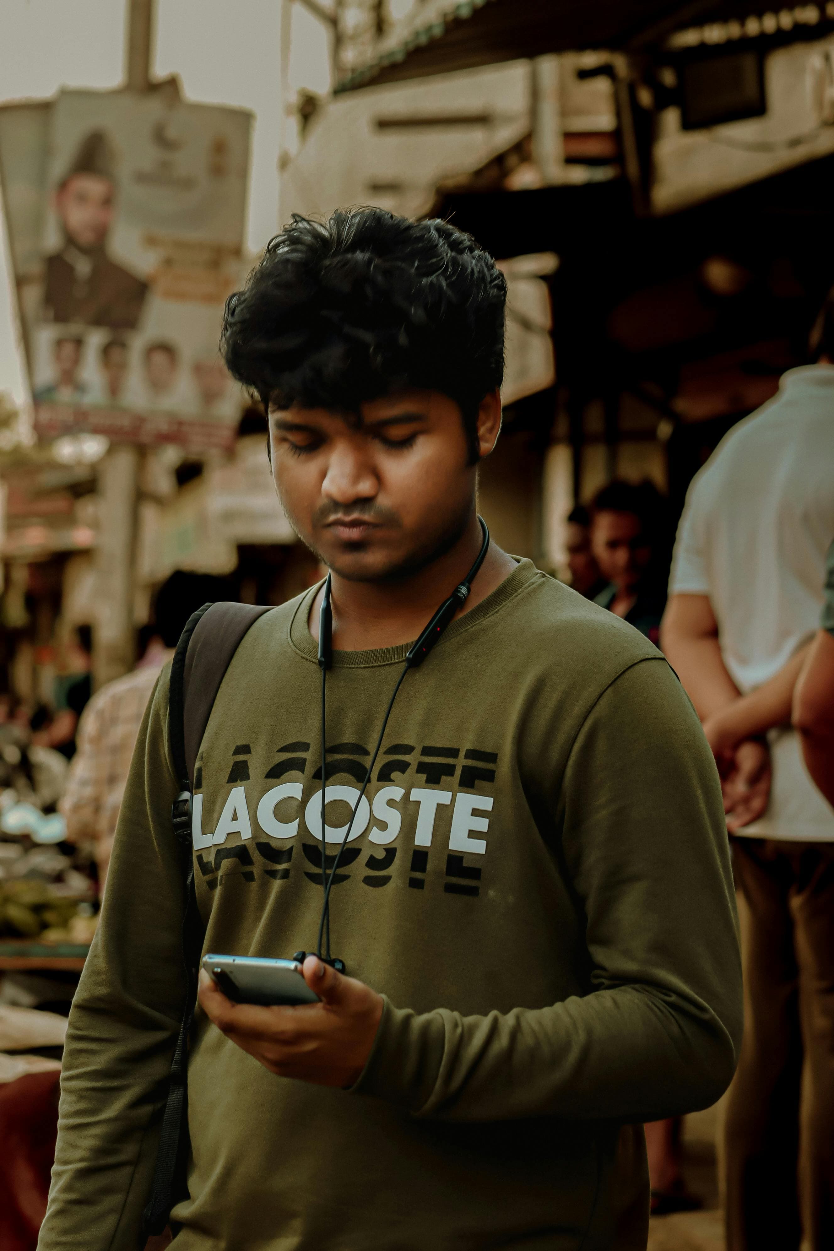 Indian man using his smartphone in Mumbai to build a profile