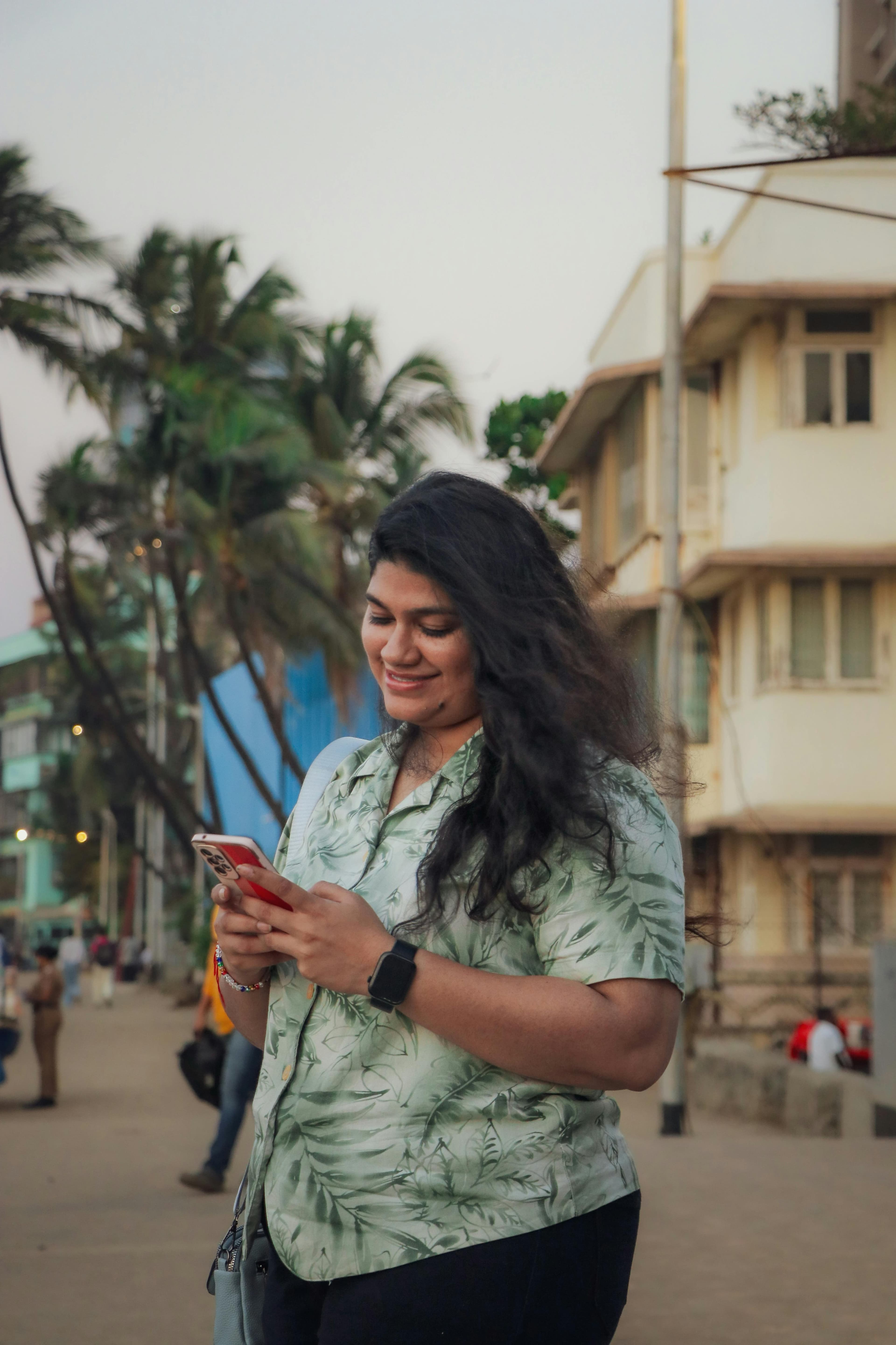 Indian woman discovering options on her smartphone outdoors